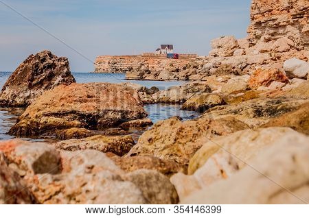 Black Sea Red Rocks Coastline. Cape Chersonesos Wild Beach In Sevastopol, Russia.