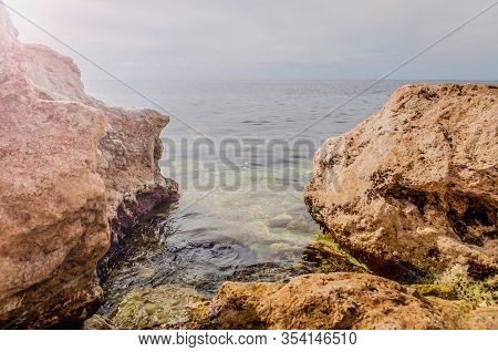 Black Sea Red Rocks Coastline. Cape Chersonesos Wild Beach In Sevastopol, Russia.