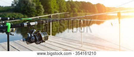 Carp Fishing On Beautiful Blue Lake With Carp Rods And Rod Pods In The Summer Morning. Fishing From 
