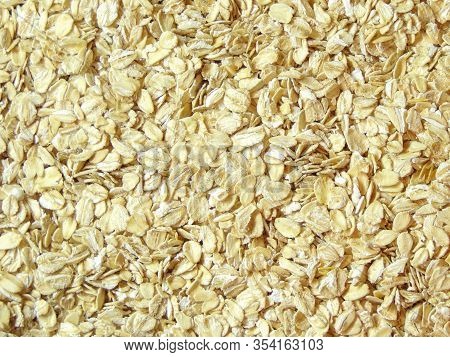 Oatmeal. Rolled Oats Background Texture. Background Useful Oatmeal For Tomorrow. Porridge For Athlet