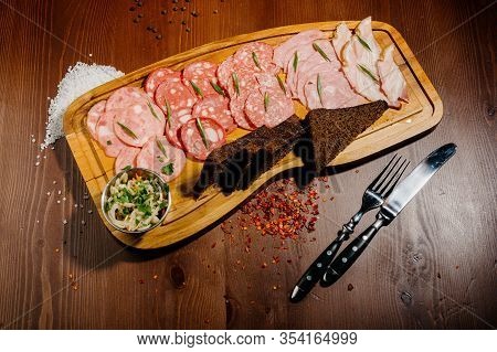 Different Types Of Sausages Served On Wooden Table