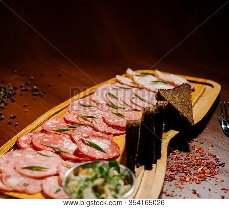 Different Types Of Sausages Served On Wooden Table