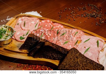 Different Types Of Sausages Served On Wooden Table