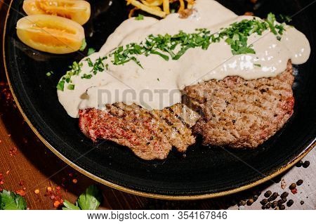 Tasty Fragrant Pork Chops Served In A Creamy Cheese Sauce In A Pan On The Table.