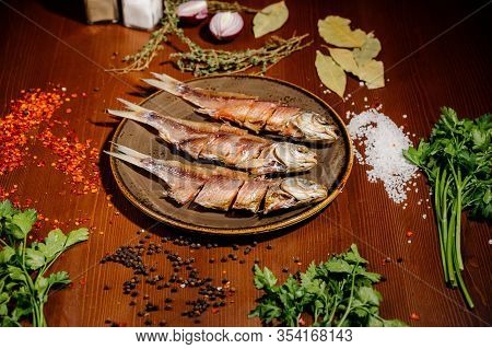 Group Of Dried Fish At Plate . Seafood