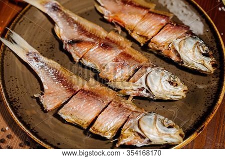 Group Of Dried Fish At Plate . Seafood