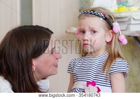 Side View Of Caucasian Mom And Daughter Having A Conversation, Girl Is Upset. Relations Between Moth