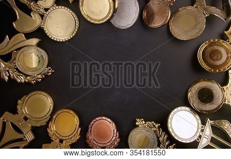 Golden trophy over blackboard background. top view. flat lay.Trophy is a specific achievement, serves as recognition / evidence of merit, awarded for sporting events