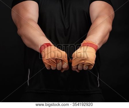 Adult Man In A Black Uniform And Muscular Body Is Standing In A Sports Stance, Wearing A Sports Elas