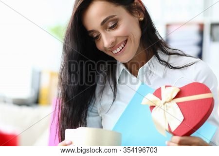 Happy Girl Looks At Gift Form Heart From Package. Use Services Personal Shoppers. Consciously Approa