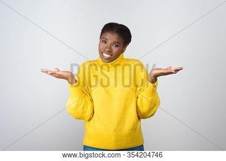 Uncertain Young Woman Looking At Camera. Portrait Of Doubtful Young African American Woman Gesturing