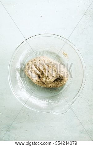 Cooking Dough For Pita Bread On A Table In A Glass Bowl, Rolling Pin And Knife