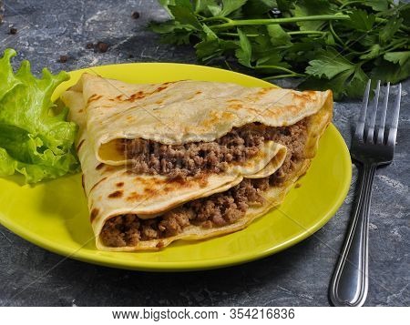Pancake With Minced Meat On A Gray Background