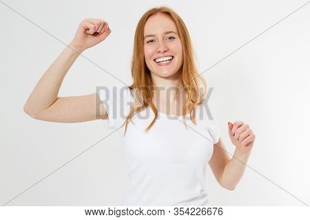 Attractive Young Red Head Woman Relax And Dance On Copy Space. Portrait Of Happy Girl In T-shirt Dan