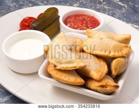 Russian Pies With Meat Posikunchiki With A Snack Of Tomatoes And Horseradish And Sour Cream