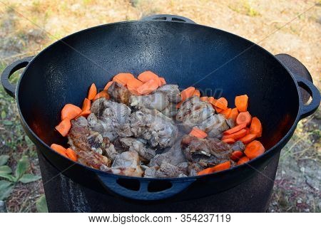 Shurpa, Lamb Soup. Caucasian Lamb Or Beef Shurpa Soup With Vegetables In A Large Cast-iron Pot On Fi