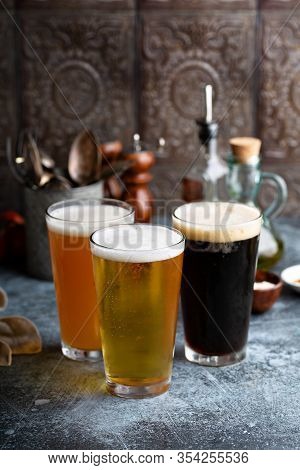 Assortment Of Beer In Tall Glasses Ina Rustic Setting