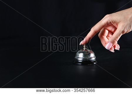 Female Hand Presses The Call Button Staff Call. Restaurant Business Or Bar. Copy Space. Photo On A B