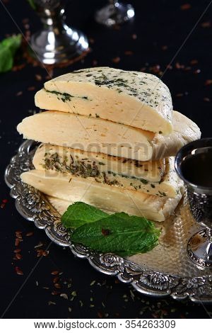 Halumi Cheese With Mint On A Vintage Tray With Vintage Silver-plated Accessories. Photo On A Black B