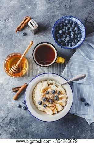 Milk Rice Porridge With Blueberry, Banana, Honey And Cinnamon, Creamy Rice Pudding Or French Riz Au 