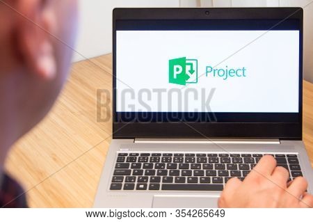 Microsoft Project Is Used By A Man On The Laptop. Microsoft Customer Used Computer Software. New Pro