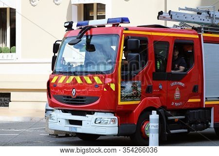 Monte-carlo, Monaco - June 20, 2019: Man Driving A Red Fire Truck Renault Midlum In Front Of The Mon