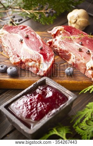 Vanison Steak Of Wild Black Boar On Old Cutting Board