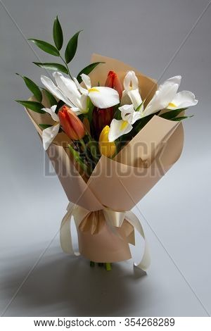 Close-up Fresh Spring Bouquet Of Tulip, Iris, Ruscus On A Gray Background, Selective Focus