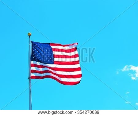 Close Up Of The American Flag Against A Blue Sky