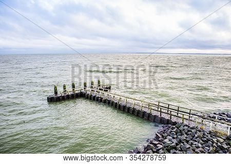 Stone Pier By The Vlietermonument Near Den Oever In Netherlands