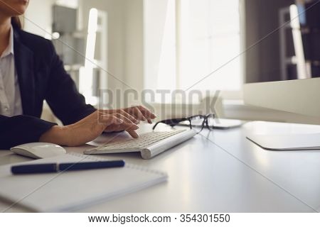 Busy Faceless Worker Is Typing At Workplace Using Computer In Office.
