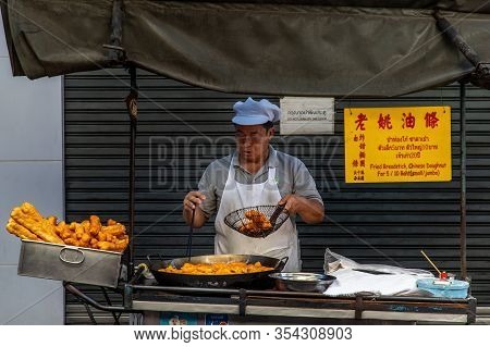 Bangkok, Thailand - Feb 16, 2020 : Chef Is Frying Chinese Deep Fried Dough In Hot Oil On Steel Pan. 