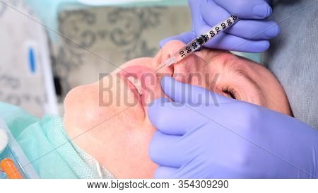 The Cosmetologist Performs A Procedure To Increase The Lips Of A Woman In A Beauty Salon. Skin Care.