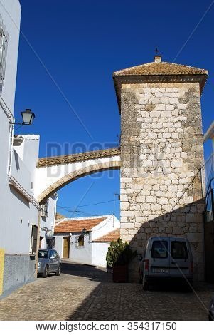 Estepa, Spain - November 13, 2008 - Village Street With Archway And Old Stone Tower, Estepa, Spain -