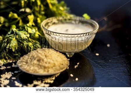 Coriander Face Mask For All Skin Types On Black Wooden Surface Along With Some Rice, And Yogurt. Hor