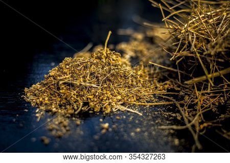 Close Up Of Shankhpushpi Roots On Wooden Surface Along With Some Of Its Powder With It. Shot With Bl