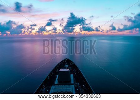 Motion Blur Of Modern Warship Sails Through The Sea With Civil Twillight Ray. Photo With Low Speed S