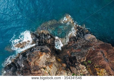 Top Aerial View Of Turquoise Atlantic Ocean Water Waves Crashing On Rocks On The Portuguese Madera I