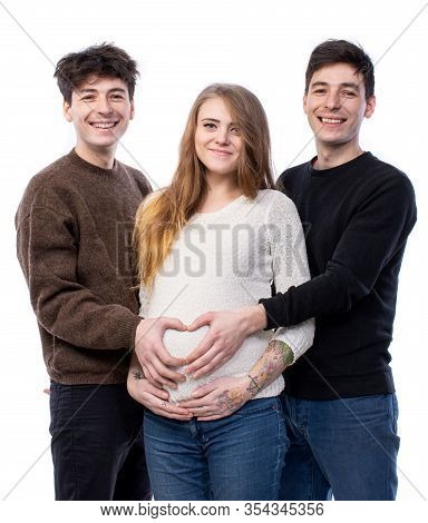 Young Pregnant Woman Posing With Two Young Man On A White Background