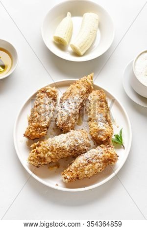 Deep Fried Bananas On Plate Over White Stone Background. Tasty Dessert From Pan Fried Bananas In Asi
