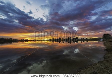 Colorful Sunrise Reflecting In A Colorado Lake Along The Front Range