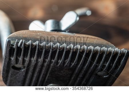 Vintage Manual Clipper. Horizontal Orientation. Wood Background. Close-up