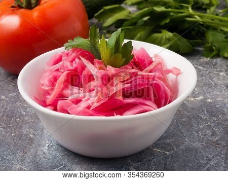 Red Sauerkraut In A White Bowl. Close Up