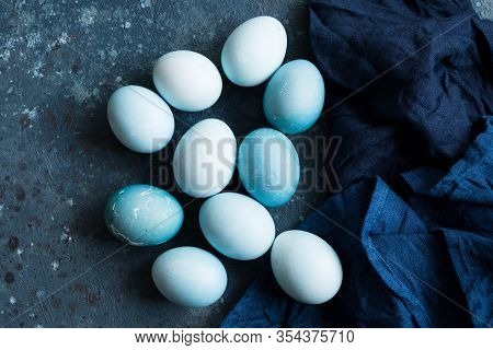 Blue Easter Eggs Painted With Natural Dye Red Cabbage On Dark Blue Concrete Background. Row Of Ombre