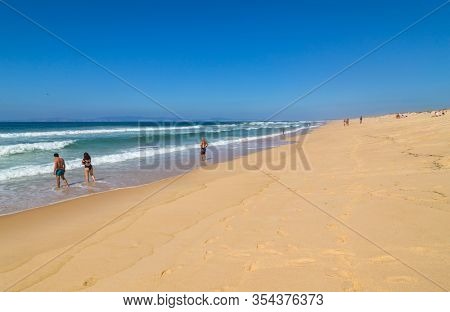 ALENTEJO, PORTUGAL - FEBRUARY 24, 2020: People at the beach in Comporta, Portugal.