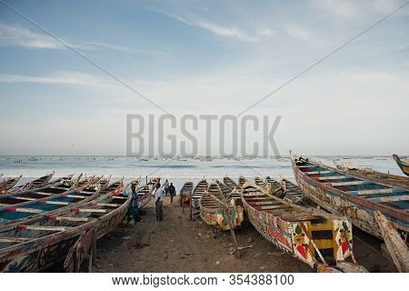 Kayar, Senegal - January 17, 2020: Traditional Painted Wooden Fishing Boat In Kayar, Senegal. Africa