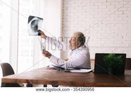 Chief Medical Officer Of The Department Analyzing Mri Scan Results Against Large Window In Modern Of