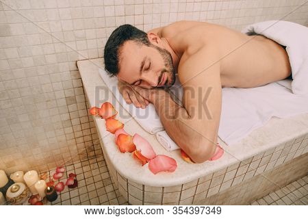 Handsome Man Relaxes On A Marble Massage Table In A Hammam. Hammam, Turkish Bath, Pilling