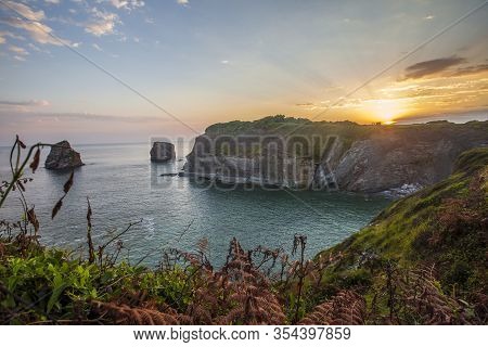 Long Exposure At Dos Hermanas At The Orange Sunrise In Hendaye In Winter, France