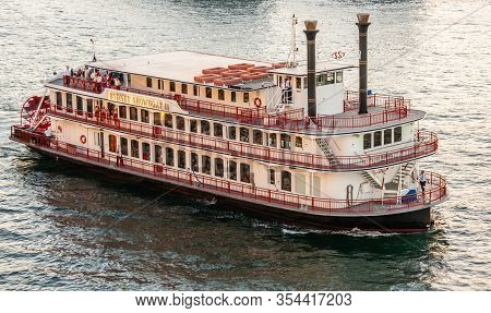 Sydney, Australia - December 11, 2009: Sunset Colors Water A Shiny Silver. Closeup Of Beige-red Miss